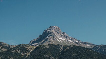 A towering summit beneath a clear azure sky