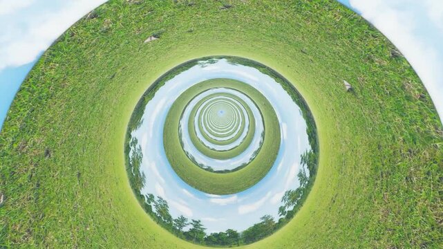 Little planet effect showing circular green landscape and sky.