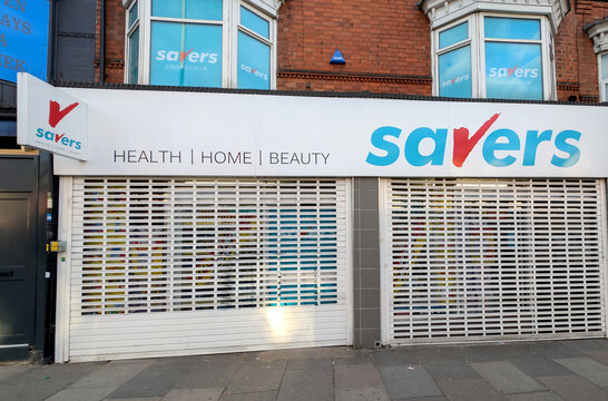 Exterior view of a closed Savers health and beauty store with a lowered security shutter | Leicester, UK, 8 May 2025