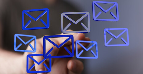 Hand interacting with digital email icons,concept of email management and digital communication.