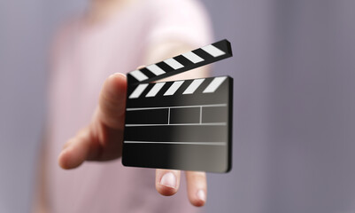 Close-up of a hand holding a digital clapperboard. Perfect for film, movie, video, and production...