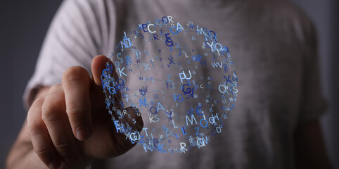 Abstract image of a hand interacting with a sphere of floating letters, representing communication,...