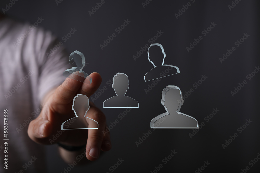 Poster hand interacts with digital profiles, symbolizing team selection and project management.