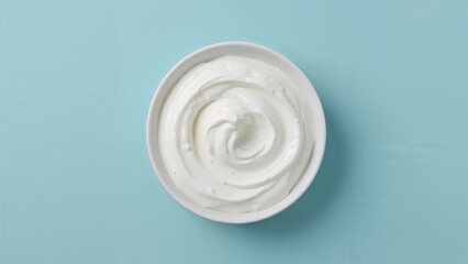 Smooth Greek yogurt and whipped cream flowing on a blue canvas