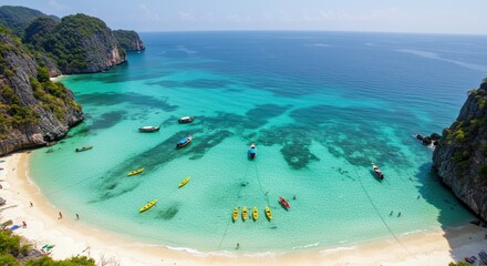 Tropical beach bay with kayaks and boats