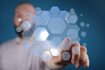 A man interacts with a futuristic digital interface.  Technology, innovation, network.