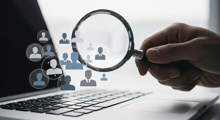 Talent Acquisition: Hand with Magnifying Glass Examining Online Profiles on Laptop for Recruitment, HR, and Business Opportunities Concept
