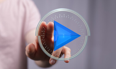 Abstract image of a hand activating a digital play button.  Perfect for technology, media, and...