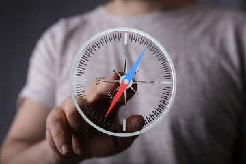 Stock photo of a person interacting with a digital compass interface, symbolizing guidance and direction.