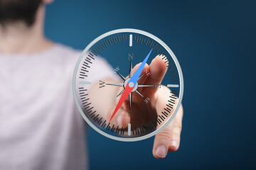 Hand interacts with a virtual compass, symbolizing guidance, direction, and strategic planning.