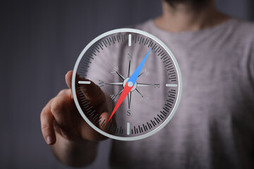 A hand interacts with a virtual compass, symbolizing guidance and direction. Ideal for business,...