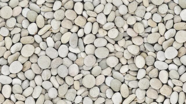 White natural pebbles surface animation in topdown loop.