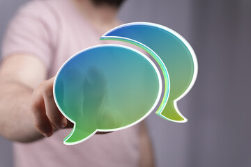 Abstract image of a person interacting with digital speech bubbles, representing communication and...