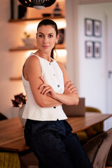 Confident middle aged portrait in her modern home