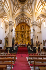 Ornate golden altar and vaulted ceiling inside Santa Maria Square Church in Baeza, Spain