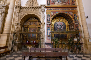 Chapels with golden altarpieces and paintings decorating Baeza Cathedral in Andalusia, Spain
