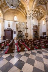 Benches and checkered floor inside the Baeza Cathedral in Andalusia, Spain