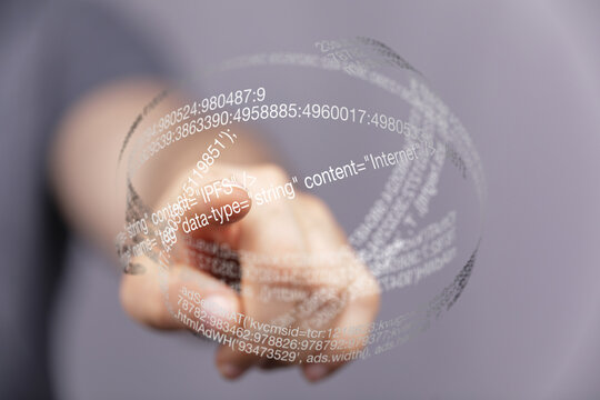 Hand points at a futuristic transparent sphere displaying digital code and data.