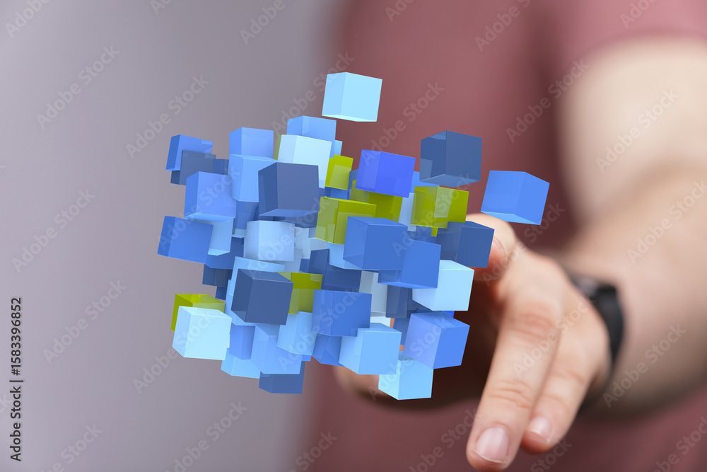 Poster abstract image of a hand interacting with a cluster of blue and yellow 3d cubes, representing data o
