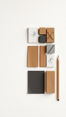 Materials arranged on a clean white surface for artistic planning, design conceptualization, or creative project development