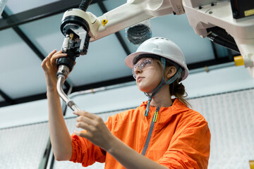 Robotic engineer women automatic mechanic checking quality system of automation robot arms machine...