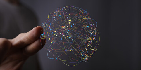 Abstract image of a digital network sphere held in a hand.  Represents connection, technology, and...