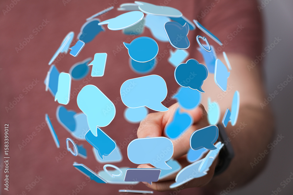 Poster abstract image of a hand interacting with a sphere of speech bubbles, representing global communicat