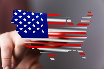 Hand interacting with a digital US map designed as an American flag. Patriotism, technology concept.