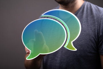 Abstract image of a person interacting with digital speech bubbles, representing communication and...