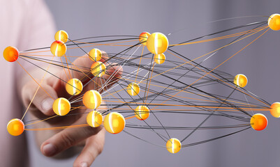 Abstract image of a hand interacting with a complex network of interconnected nodes, representing...