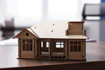 House model on desk in real estate agent's office, closeup
