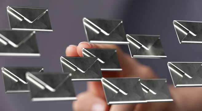 A hand interacts with digital email icons, symbolizing inbox management.