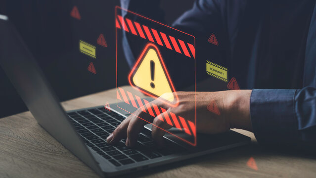 Cybersecurity warning alert on computer screen while working, showing digital threat detection and risk of system breach in a secure environment. - Powered by Adobe
