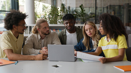 Group of multiracial diversity students e-learning together studying in high school pupils...