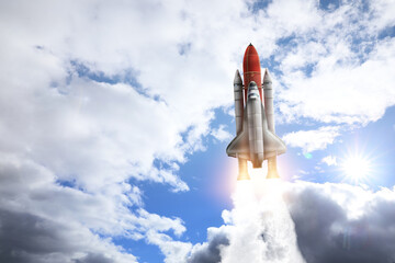 Modern space rocket in beautiful cloudy sky