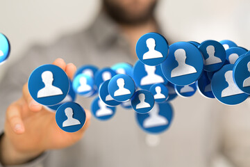 Hand interacting with floating profile icons symbolizing social media, networking, and online...