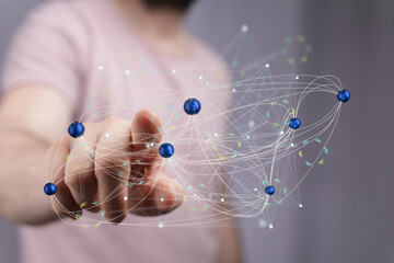 Abstract image of a hand interacting with a complex network, representing connection, technology,...