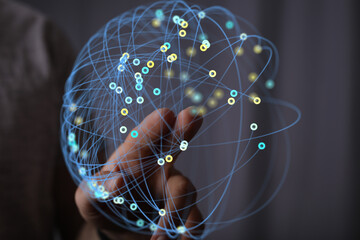 Abstract image of a hand interacting with a digital network. Represents connection, technology, and...