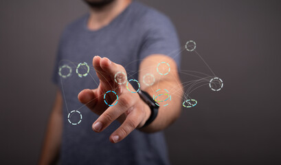 Close-up of a man's hand interacting with a digital network visualization.  Modern technology...