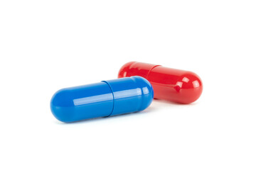Red pill or blue pill? A conceptual choice between two medicine capsules, a metaphor for a critical decision, truth, or illusion in healthcare. isolated on white background with clipping path.