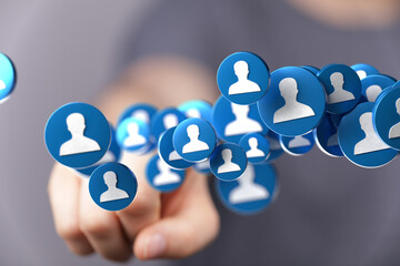 Image of hand interacting with floating profile icons, representing social media connections and...