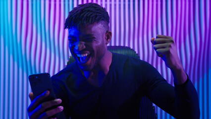 African American man guy male indoors futuristic innovation cyberspace neon lights winning with...