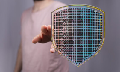 Hand holding a digital shield, symbolizing online security and data protection.