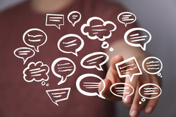 Hand interacting with digital speech bubbles, representing communication, ideas, and feedback.