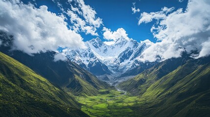 Obraz premium Magnificent mountain scenery with snow peaks, green hills and blue sky