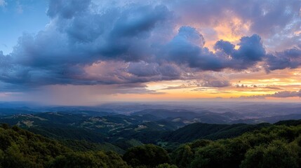 Obraz premium Breathtaking Sunset Over Mountain Landscape with Dramatic Clouds and Vibrant Colors in the Sky