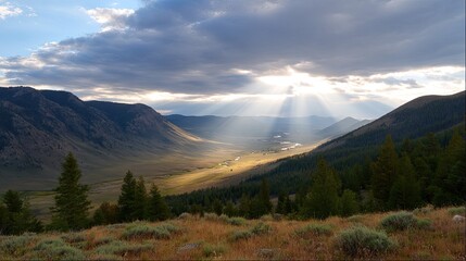 Fototapeta premium Majestic Mountain Landscape with Sunlight Breaking Through Clouds Over a Serene Valley