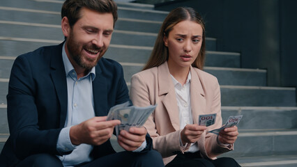 Caucasian colleagues man woman count money salary business financial inequality envy offended...