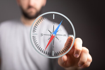 Conceptual image of a person using a digital compass, representing guidance, direction, and...
