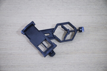 Telescope smartphone adapter for astrophotography. A telescope parts on white fabric. Astronomy...